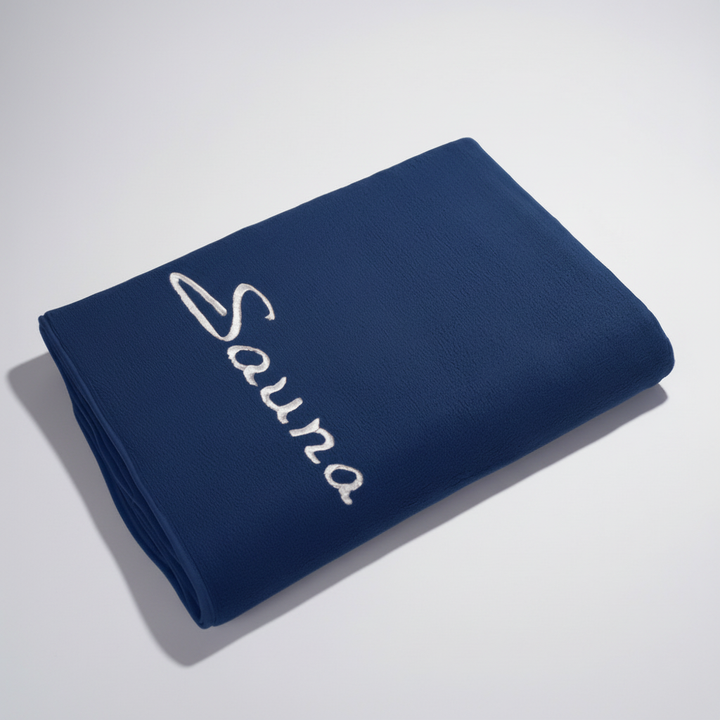 Rolled white microfiber spa towel, lightweight and compact for easy packing