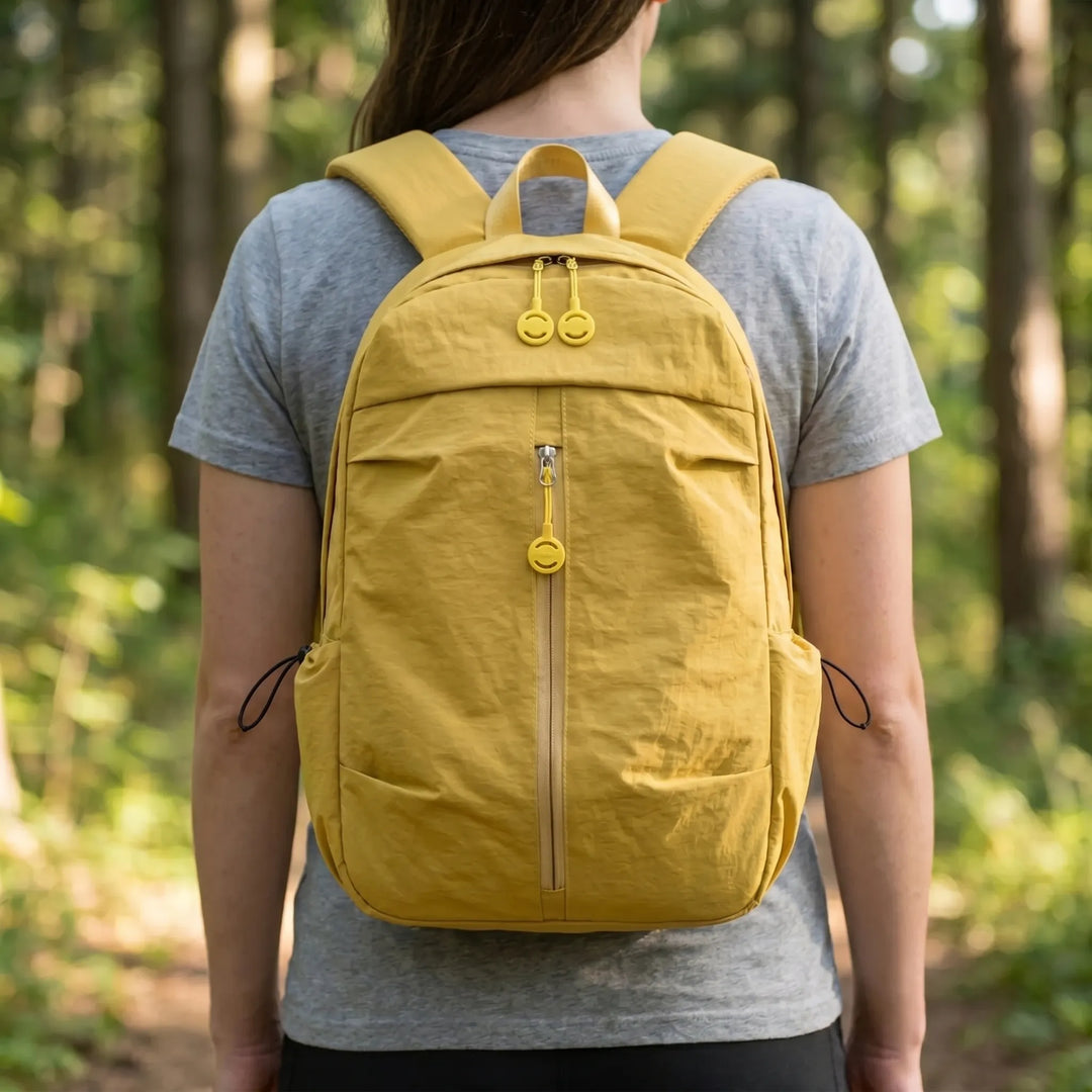 Unisex minimalist everyday backpack in black, perfect for urban commute or light travel, lightweight and durable nylon.