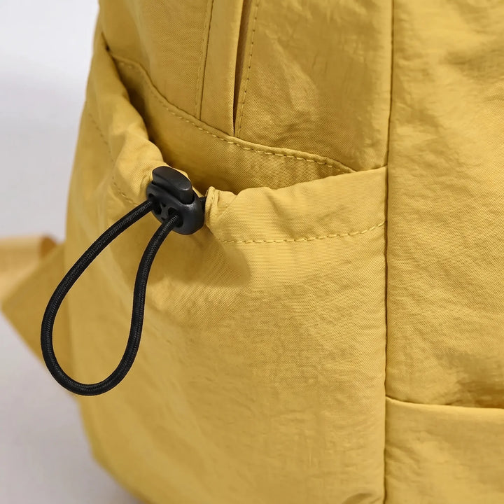 Durable everyday minimalist backpack, spacious & versatile for daily use, unisex design, tough nylon material.