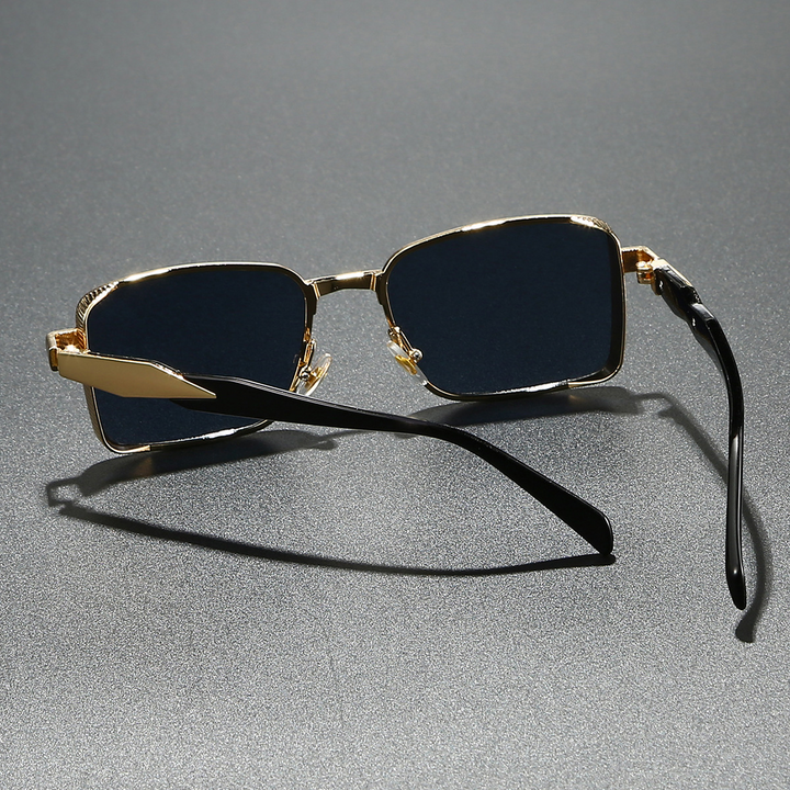 Close-up of modern square unisex sunglasses. Features sleek alloy frame & lenses providing full UV eye protection.