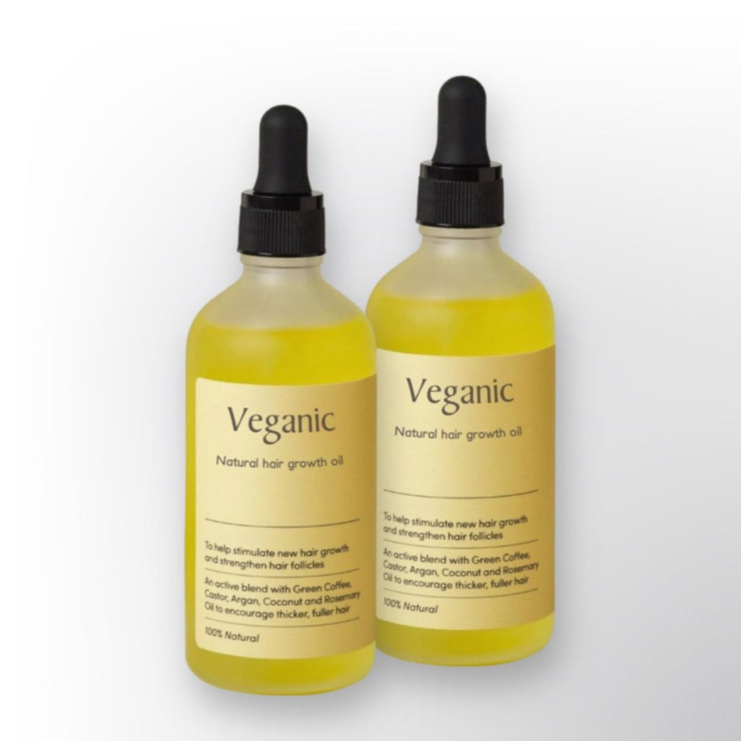 Close-up of Unisex Natural Hair Growth Oil bottle. Organic formula for nourishing scalp, strengthening hair, and growth.