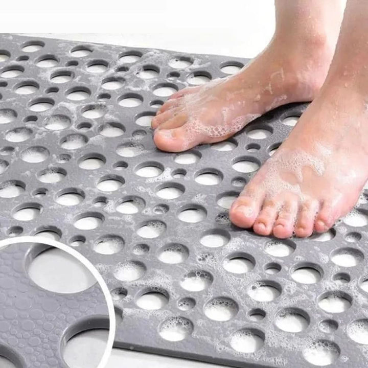 Textured non-slip bath mat ensures secure footing, preventing slips & falls in showers.