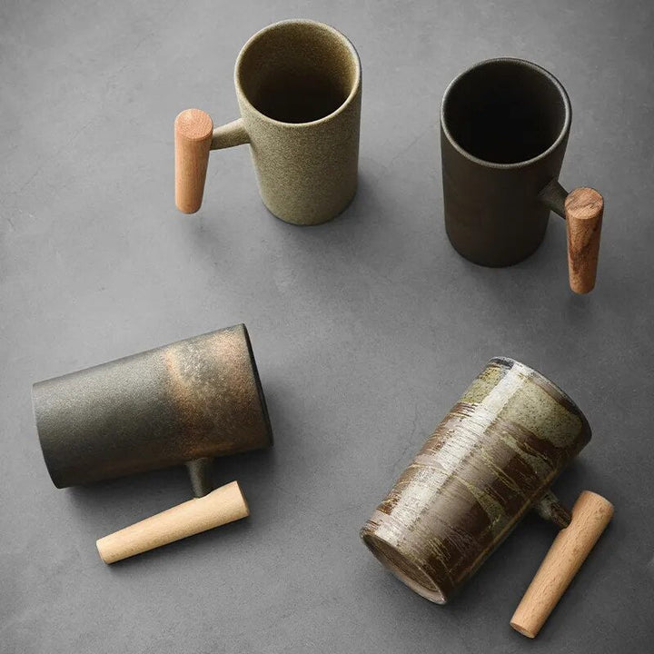 Nordic latte mug featuring a warm earthy ceramic body & ergonomic wooden handle, ideal for coffee & tea.