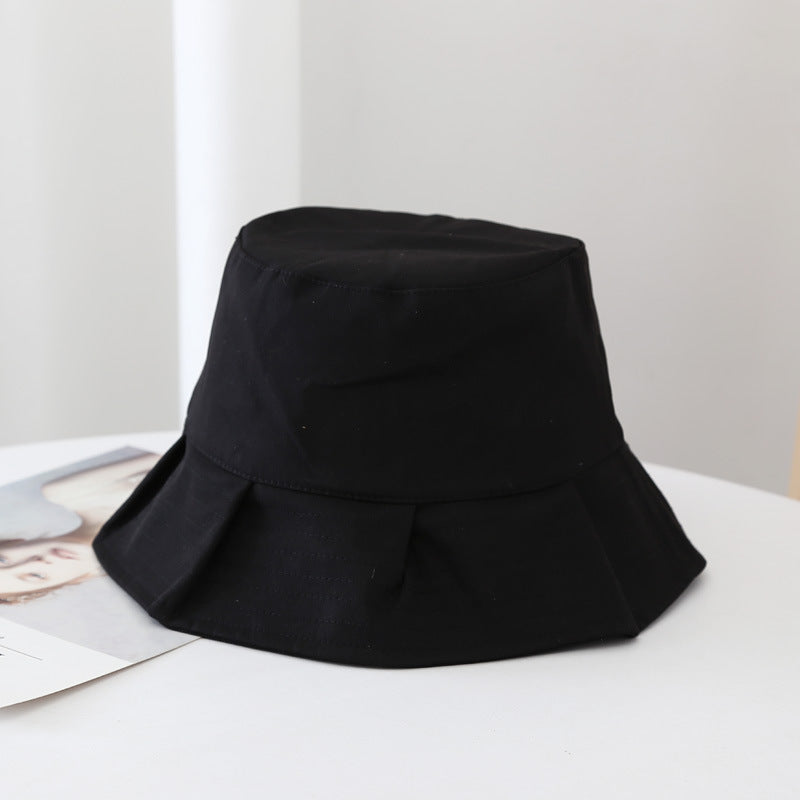 Black unisex summer bucket hat, essential fashion accessory for sun protection.