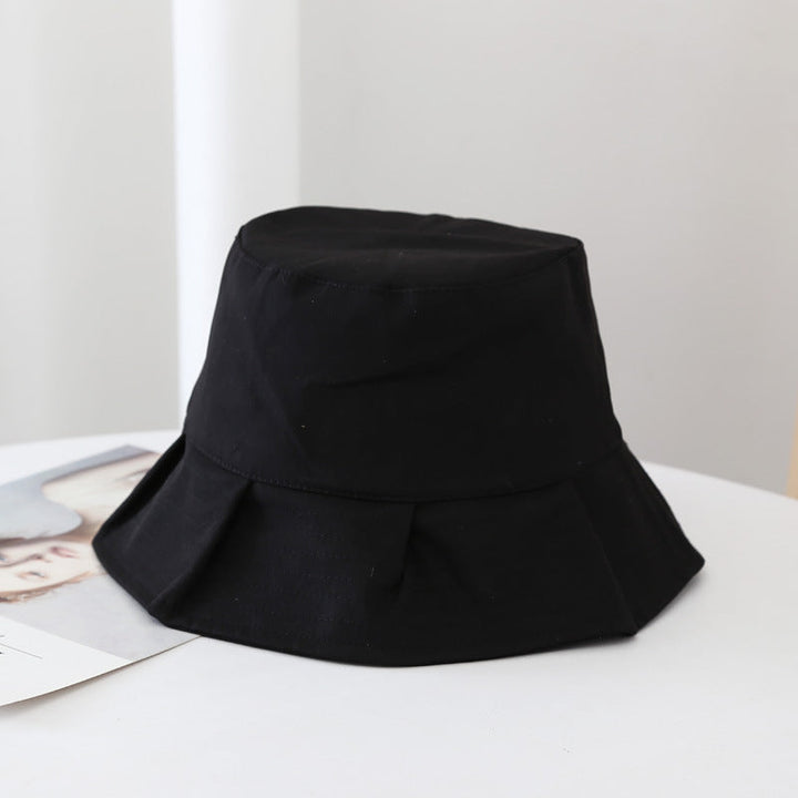 Black unisex summer bucket hat, essential fashion accessory for sun protection.