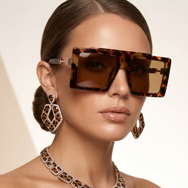 Chic black oversized square frame sunglasses. Unisex fashion shades offering essential UV400 eye protection.