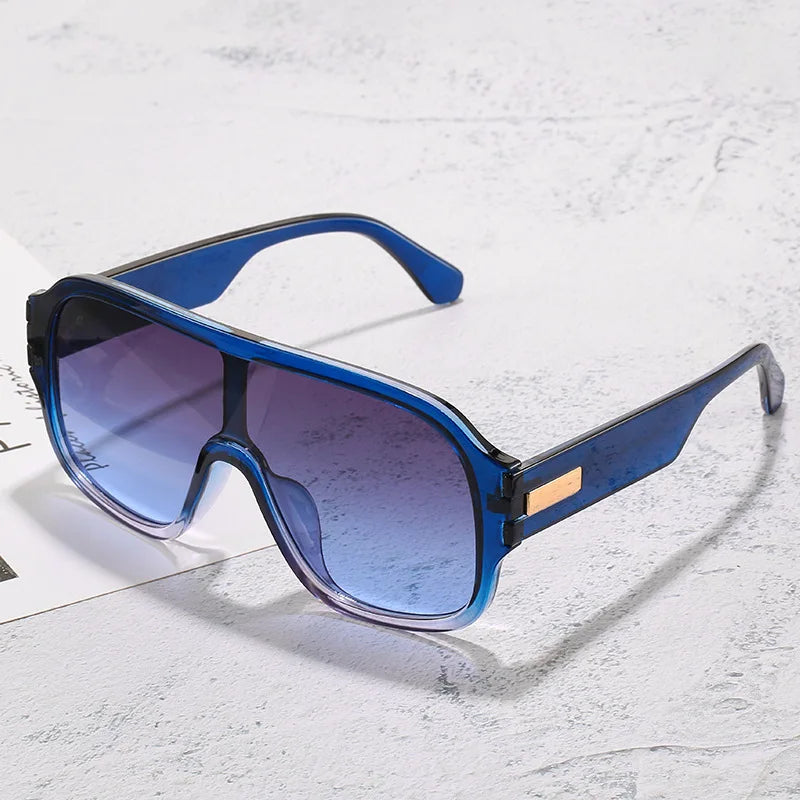 Unisex oversized sunglasses with stylish gradient lenses and metal accents for modern eye protection.