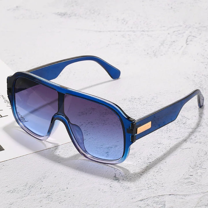 Unisex oversized sunglasses with stylish gradient lenses and metal accents for modern eye protection.