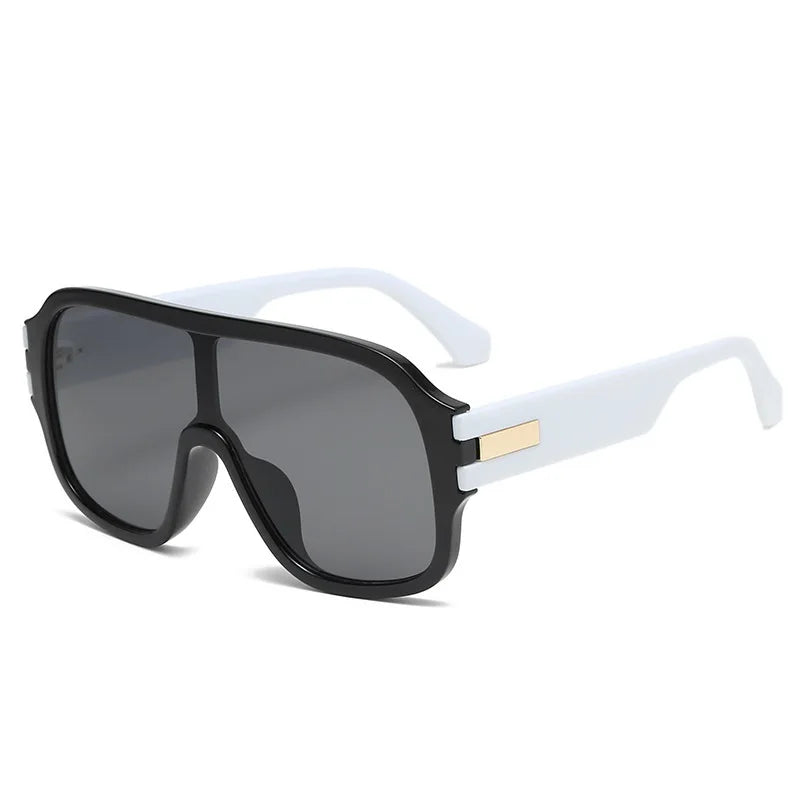 Fashionable unisex oversized sunglasses, offering eye protection with stylish gradient lenses and elegant metal accents.