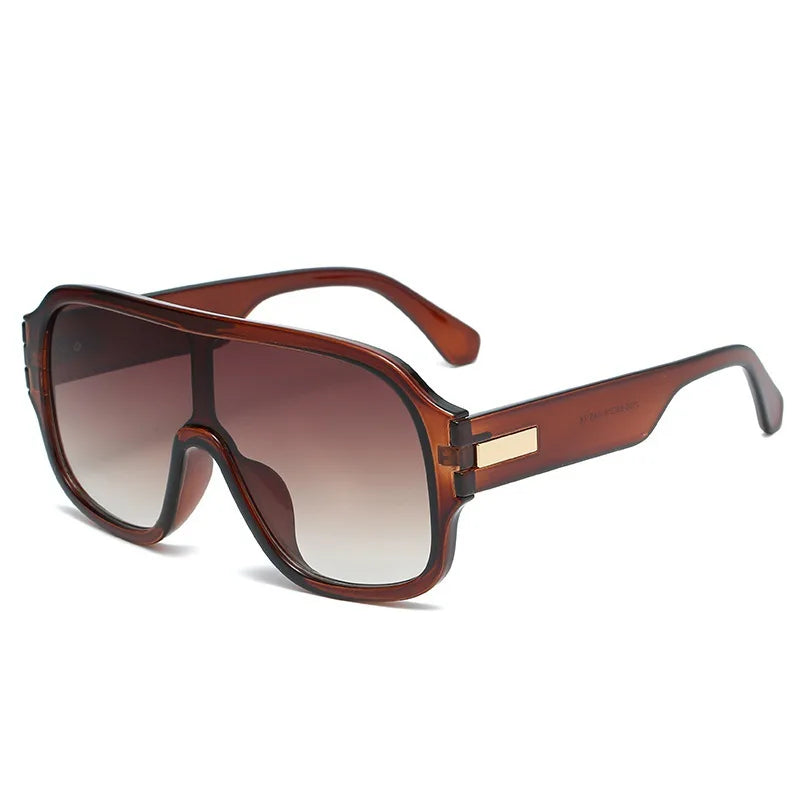 Modern style unisex oversized sunglasses featuring unique gradient lenses and subtle metal frame accents.