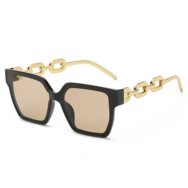 Striking oversized unisex sunglasses with dark lenses and elegant gold-tone chain temples, a trendy fashion accessory.