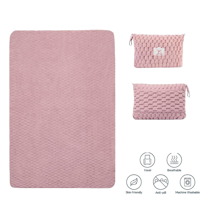 Folded grey flannel travel blanket converting into a compact pillow with zipper closure
