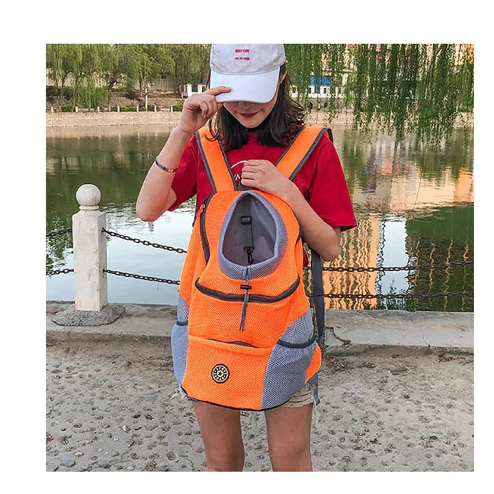 Unisex pet carrier backpack for dogs & cats, hands-free travel, breathable mesh, durable fabric.