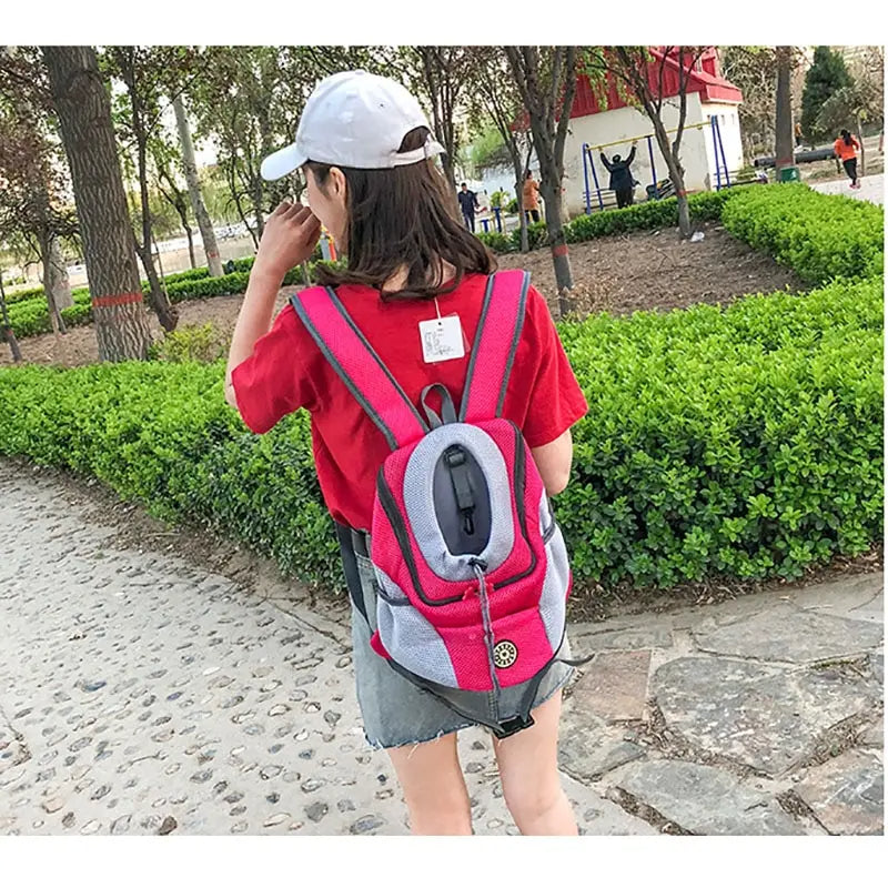 Person hiking with a hands-free dog & cat travel backpack, ergonomic design for comfortable, long treks.