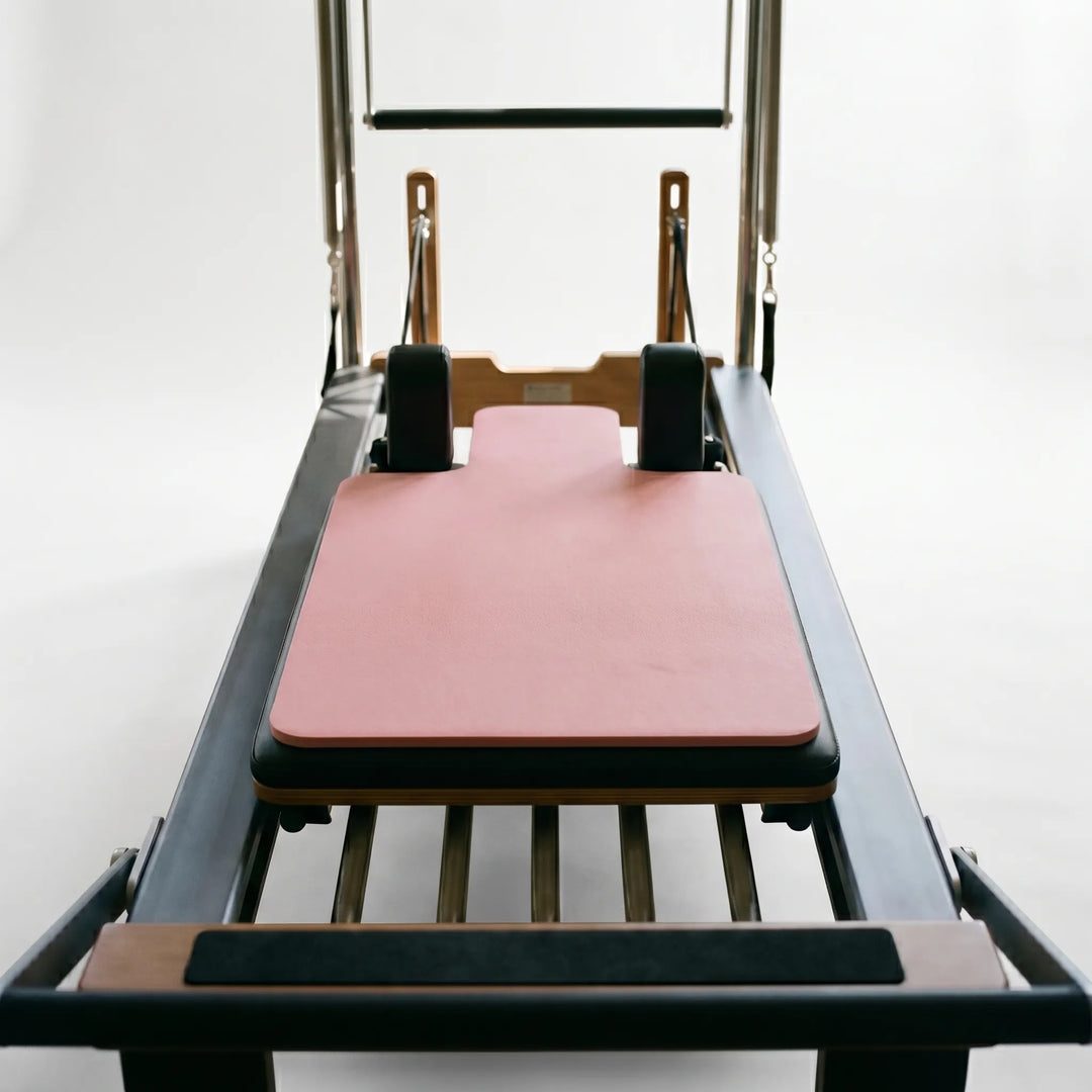 Close-up of the comfortable, non-slip Pilates Reformer Pad, optimizing grip for studio exercises.