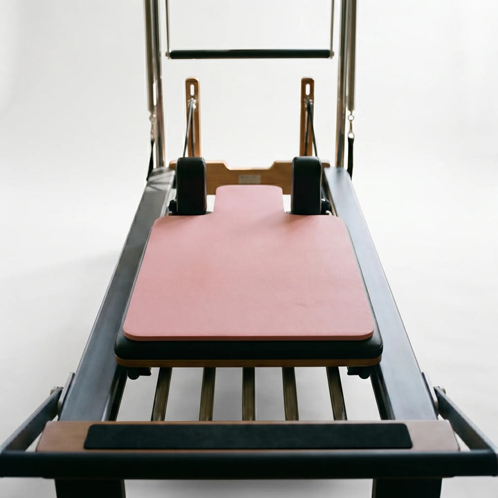 Close-up of the comfortable, non-slip Pilates Reformer Pad, optimizing grip for studio exercises.