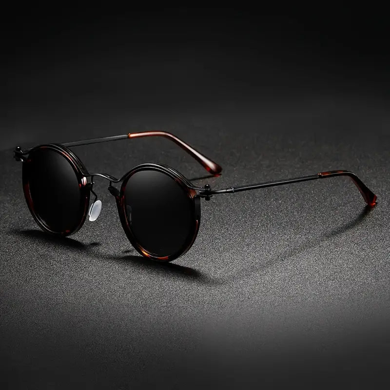 Black unisex polarized sunglasses, metal frame, anti-reflective lenses. Stylish outdoor eyewear with UV & glare protection.
