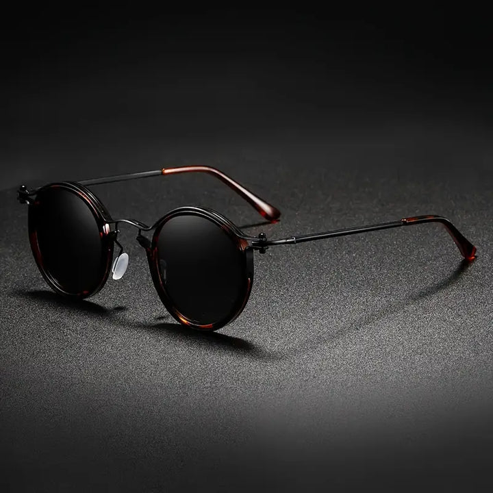 Black unisex polarized sunglasses, metal frame, anti-reflective lenses. Stylish outdoor eyewear with UV & glare protection.