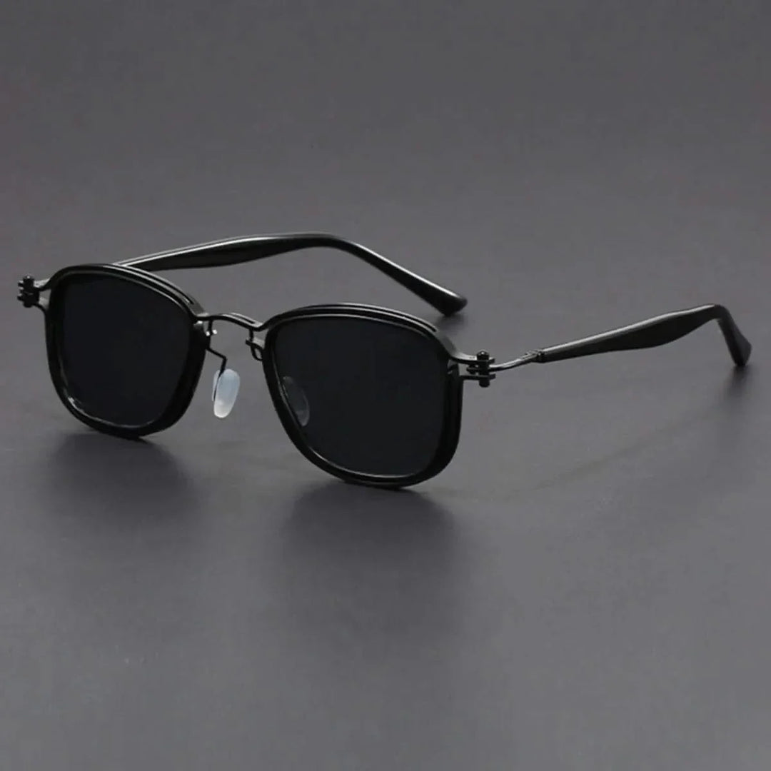 Stylish unisex eyewear with gold metal frame & black polarized lenses, modeled to showcase fashion appeal. UV protection.