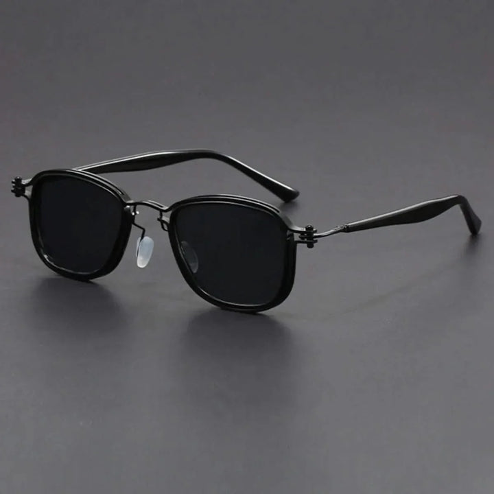 Stylish unisex eyewear with gold metal frame & black polarized lenses, modeled to showcase fashion appeal. UV protection.