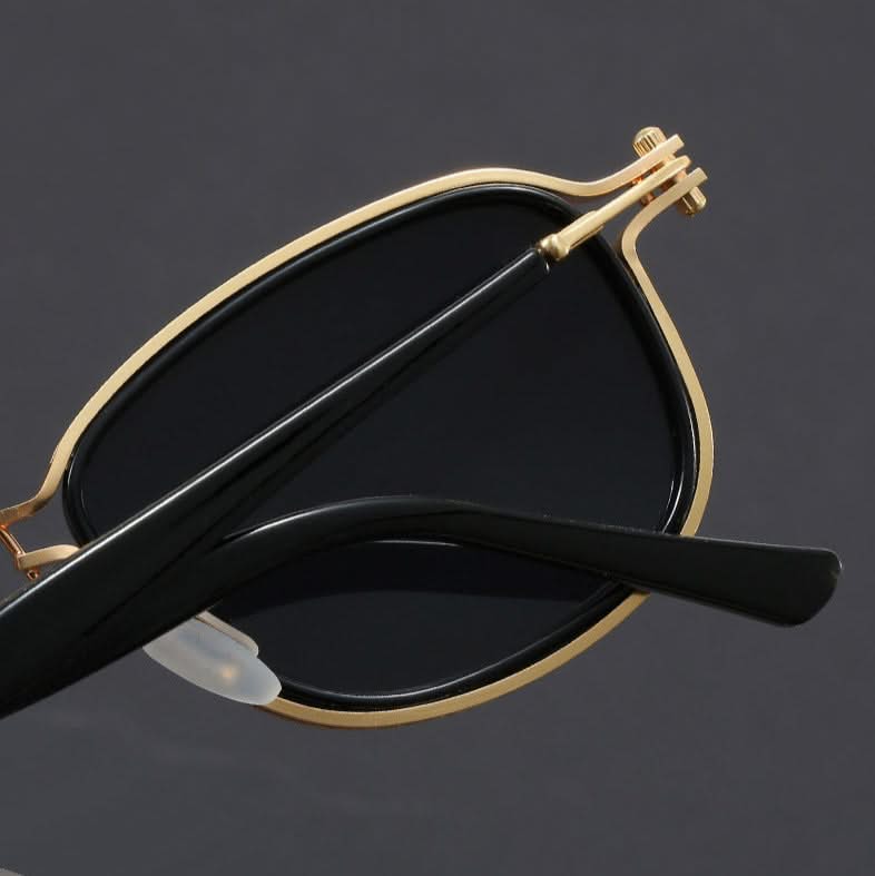Fashionable unisex polarized sunglasses with gold metal frame & black lenses, perfect for sun protection & style.