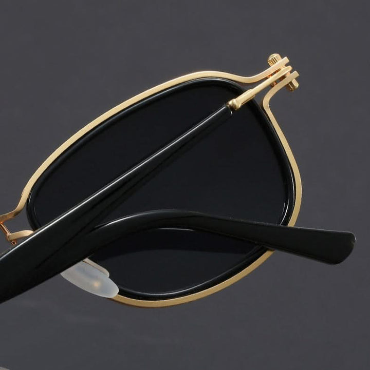 Fashionable unisex polarized sunglasses with gold metal frame & black lenses, perfect for sun protection & style.
