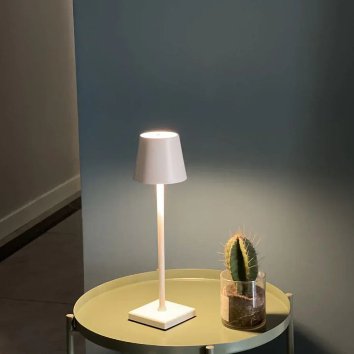 Stylish portable LED table lamp, casting a warm, dimmable glow, ideal for home decor