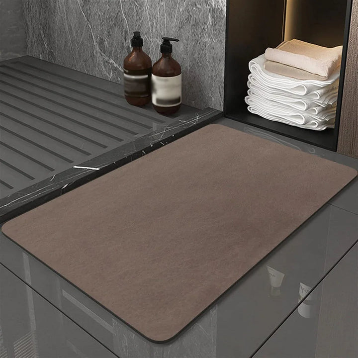 Anti-slip diatomite bath mat securely placed on a bathroom floor, ensuring safety and quick drying.