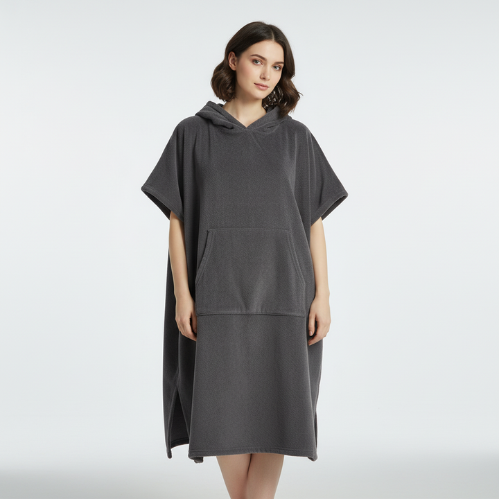 Unisex quick-dry microfiber poncho for watersports, shown in a folded state, highlighting its compact travel size