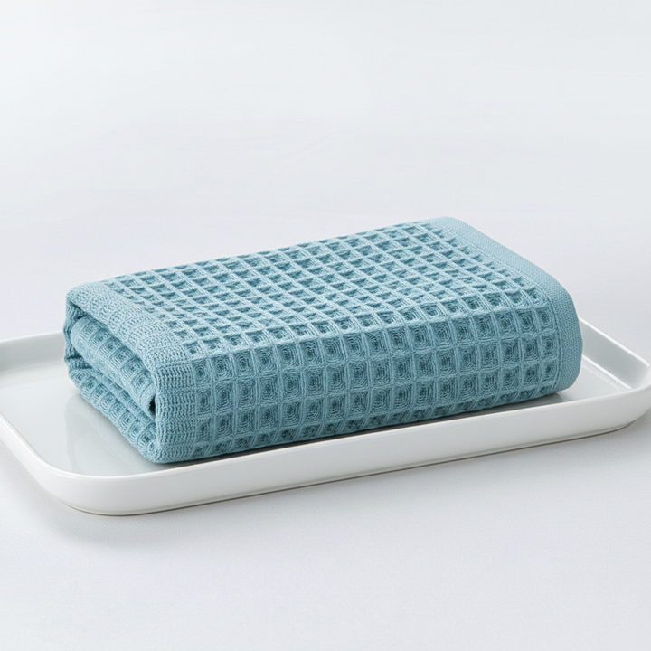 Close-up of a blue unisex waffle towel showing its quick-drying texture and absorbency.