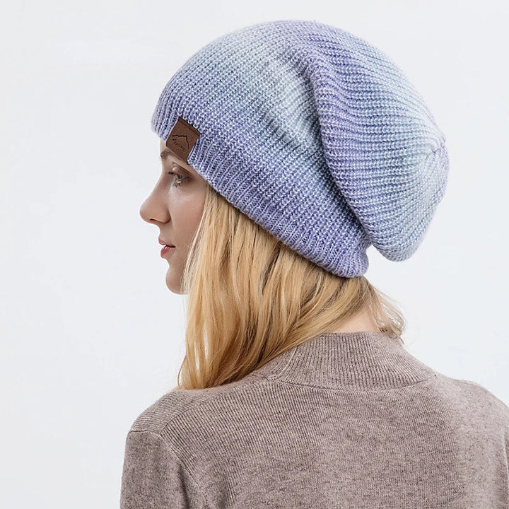 Soft knit rainbow beanie hat for unisex winter fashion. Warm, colorful, and stylish.