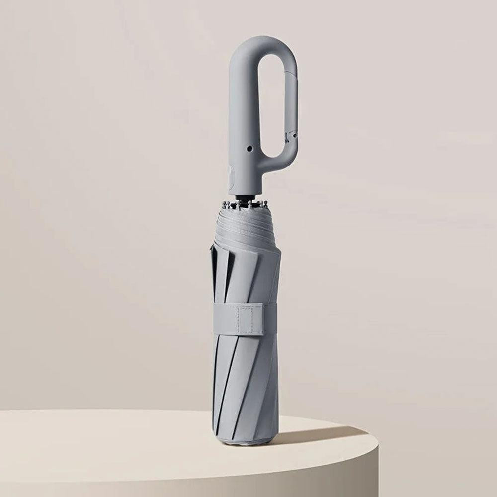 Ultra-compact unisex travel umbrella, reinforced & windproof for easy portability & reliable rain/sun protection.