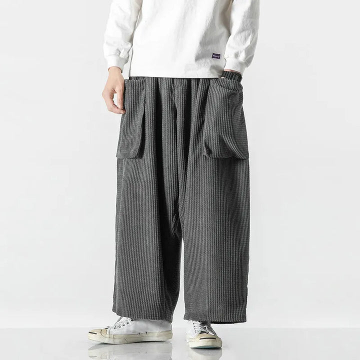 Model wearing unisex relaxed fit comfort sweatpants, showing straight leg and drawstring waist detail.