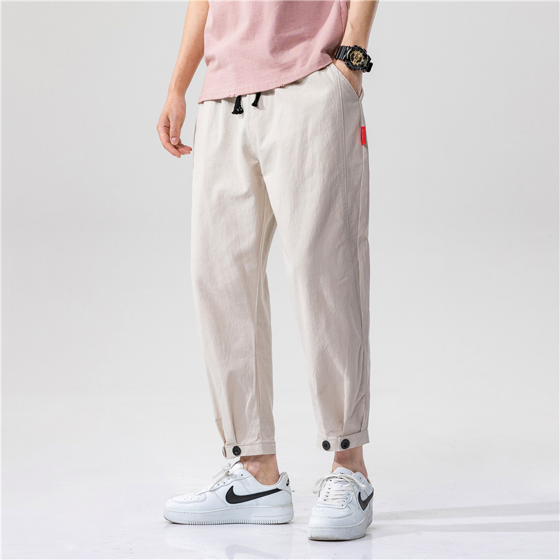 Unisex relaxed fit linen blend trousers in a light color, perfect for casual summer comfort & breathability.