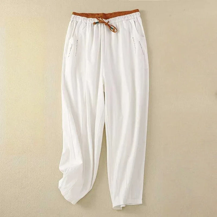 Unisex relaxed fit linen pants in natural beige, perfect for breathable summer comfort & casual wear.