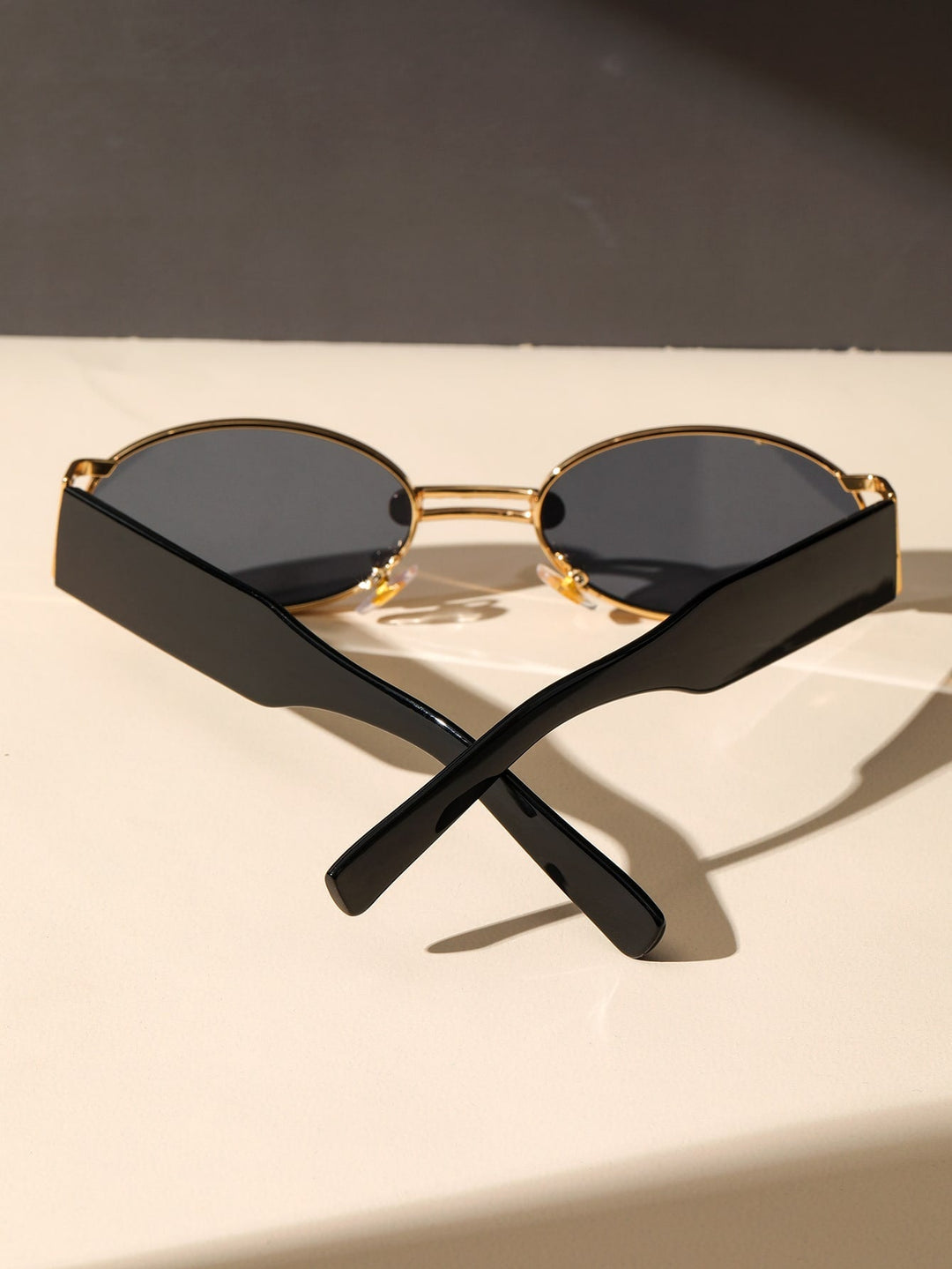 Close-up of sleek retro modern sunglasses. Black frames, UV protective lenses for all.
