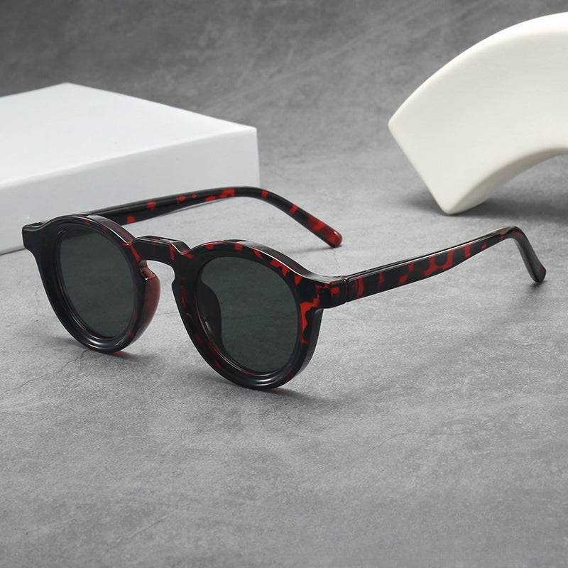 Classic retro round sunglasses, unisex sculpted frame for timeless fashion eyewear.