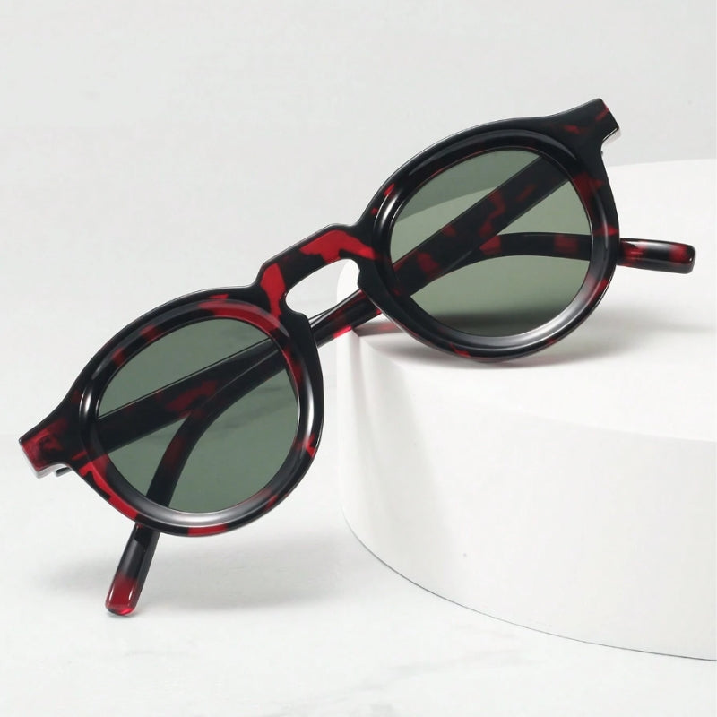 Trendy unisex retro shades, sculpted round design, acetate frame for ultimate eye protection.