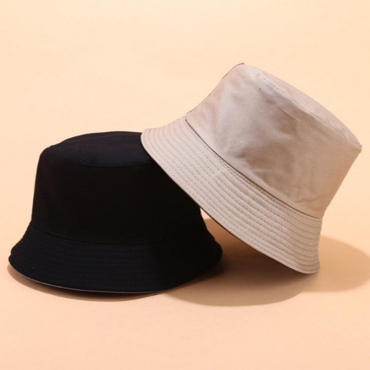 Person wearing a unisex reversible bucket hat, providing sun protection for outdoor activities