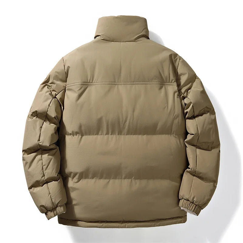 Unisex reversible winter jacket with functional utility pockets, offering warmth and versatile cold weather style.