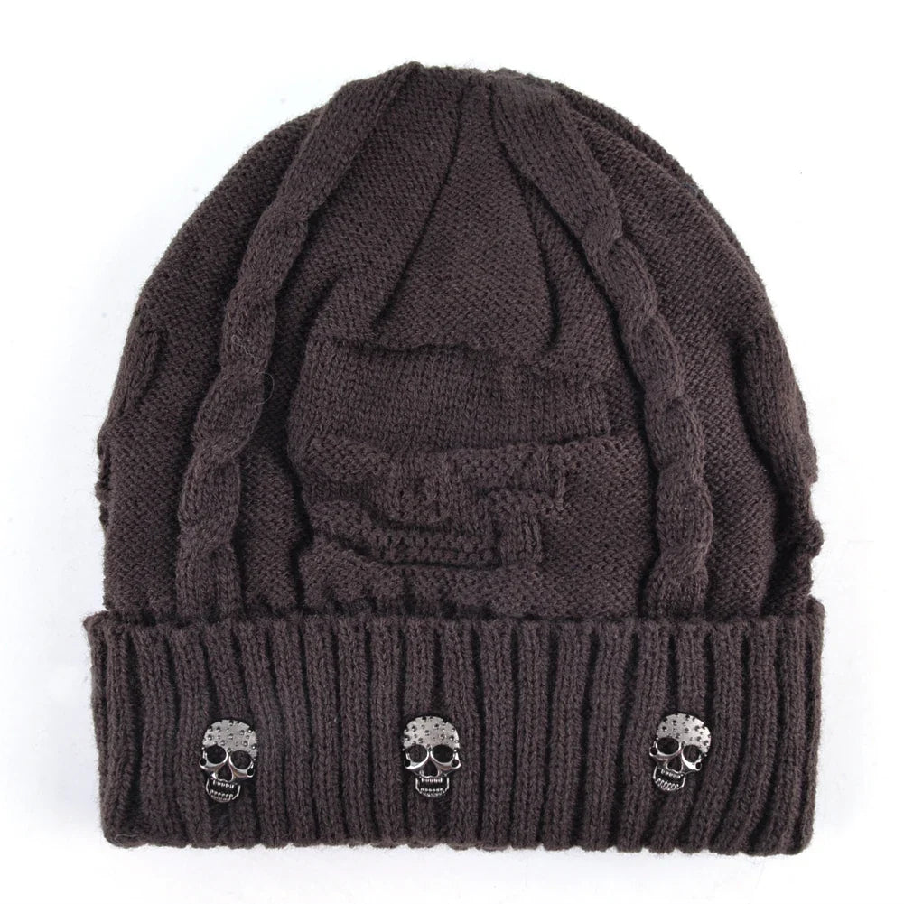 Comfortable knit skull cap in shadow black, featuring eye-catching metallic skulls. Unisex design.