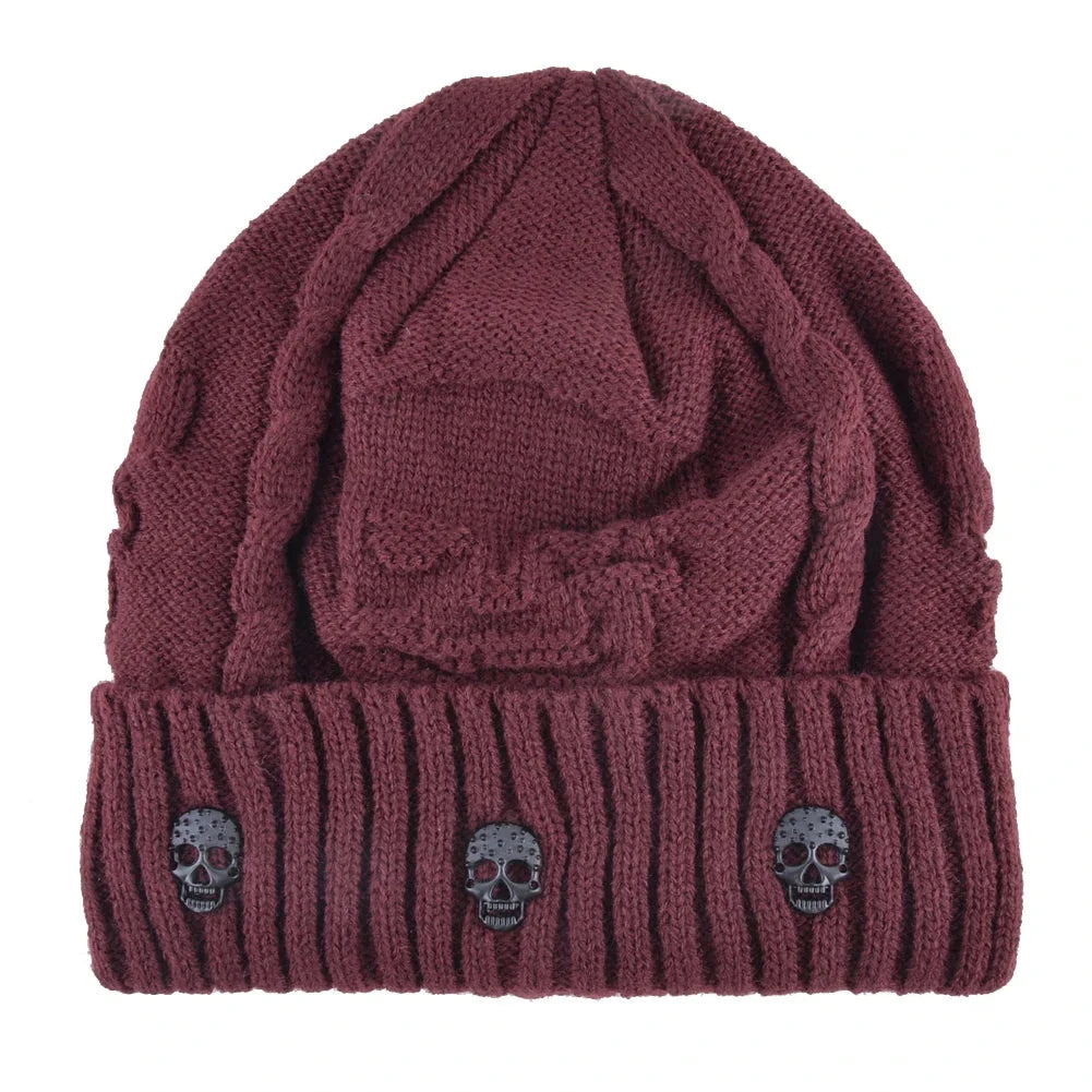 Unisex winter beanie with an edgy design: metallic skulls on a shadow knit cap. Stay warm in style.