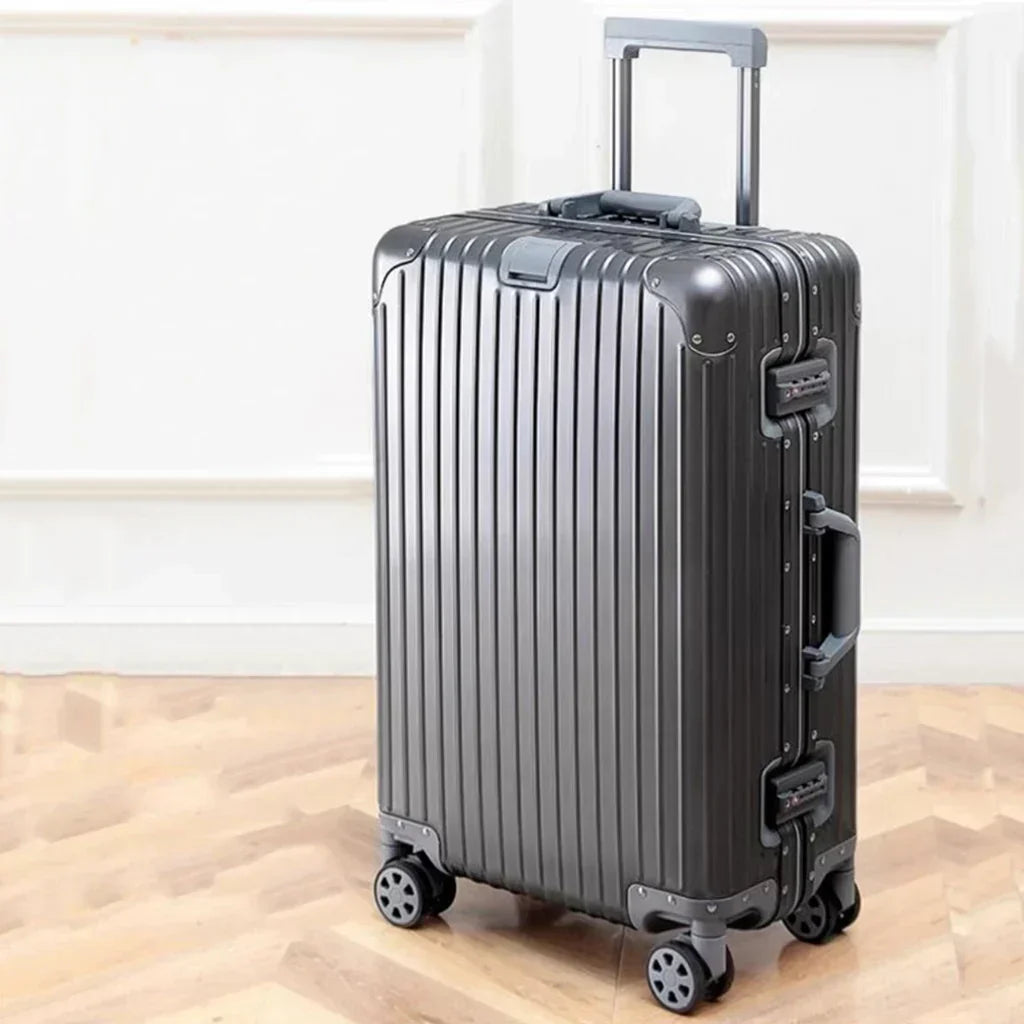 Durable 360-degree spinner wheels on a sleek aluminum hard shell luggage, ensuring smooth & easy travel.