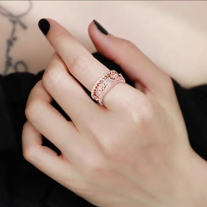 Hand holding a unisex anti-anxiety spinner ring, promoting calm and stress reduction.