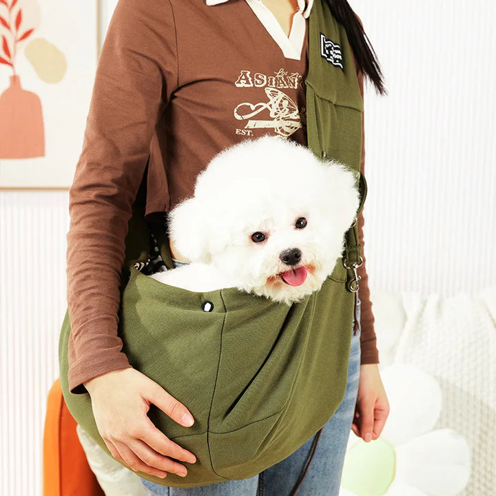 Unisex sling pet carrier for small dogs & cats, featuring an adjustable shoulder strap for comfort & hands-free travel.