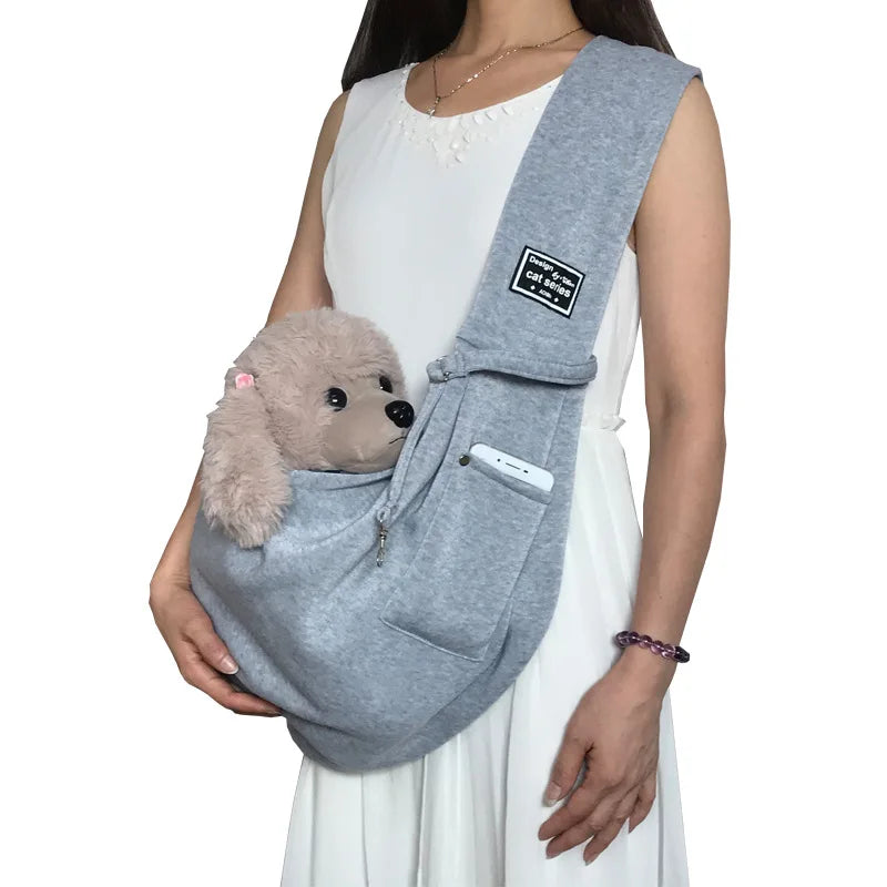 Durable pet sling carrier with an adjustable shoulder strap, perfect for small dogs, puppies, & cats.