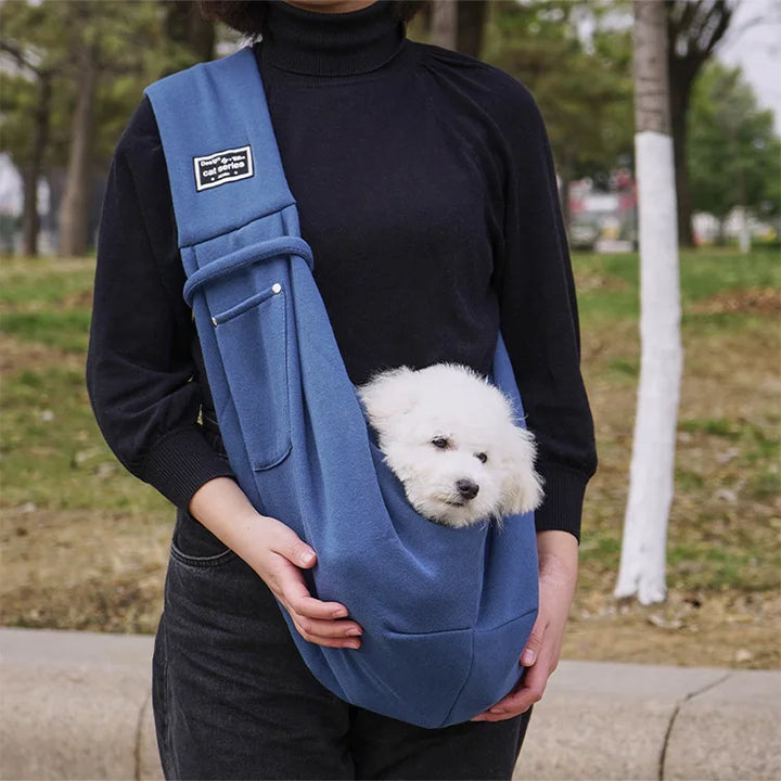 Lightweight, hands-free pet travel sling carrier for small pets; features an adjustable strap & secure design.