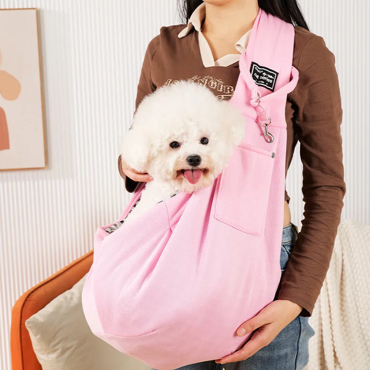 Cozy small dog carrier sling with an adjustable strap, offering comfort for puppies & convenient pet travel.