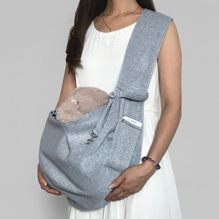 Practical pet sling carrier for small dogs & cats; adjustable strap ensures secure, comfortable pet travel accessory.