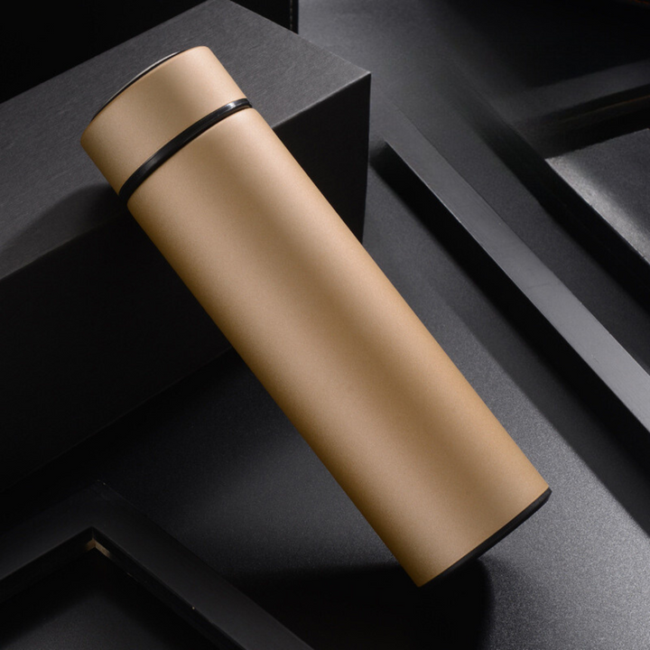 Close-up of smart digital temperature display on a sleek stainless steel thermos flask, showing current temp.